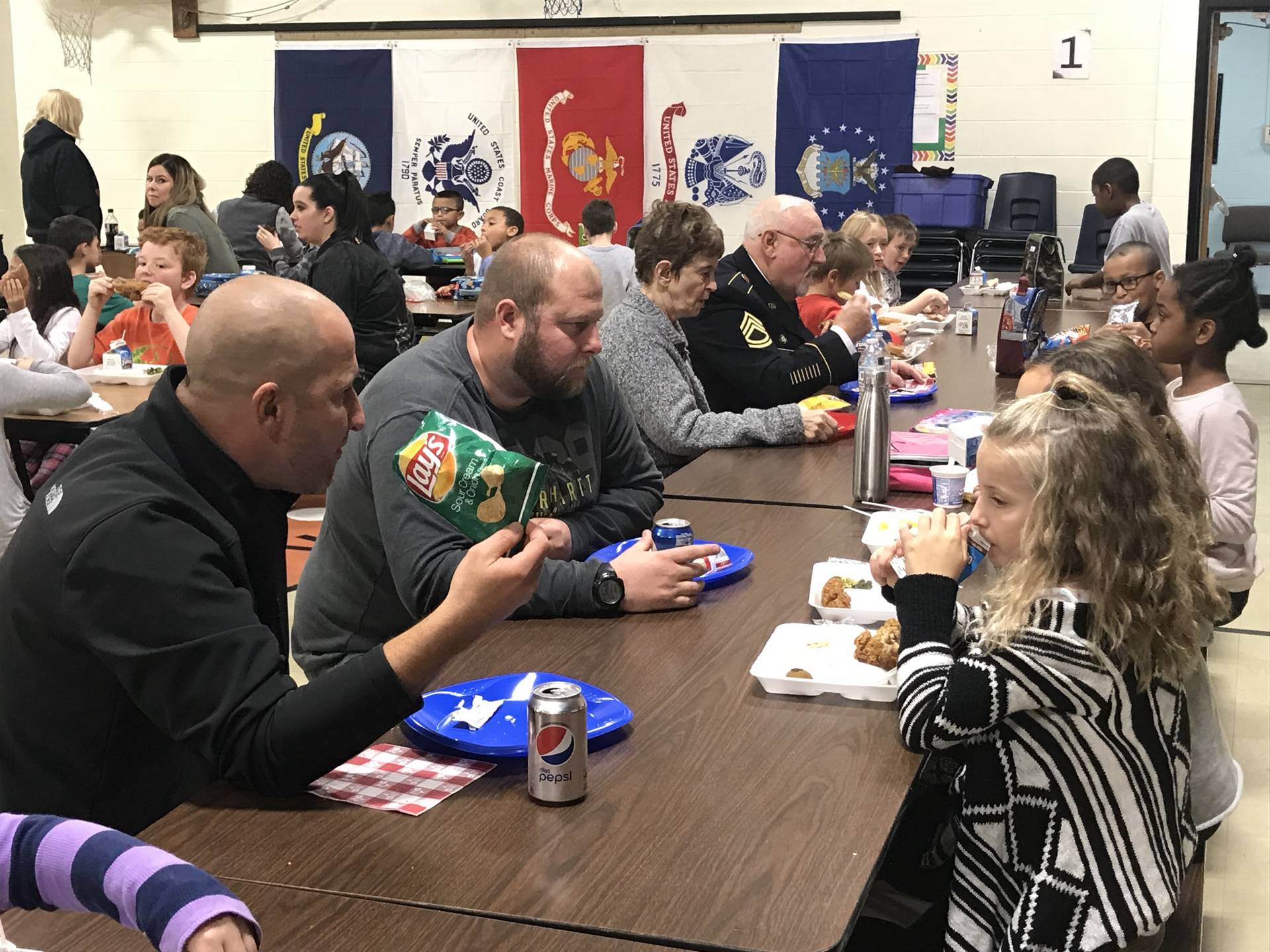 Veterans eating lunch with students