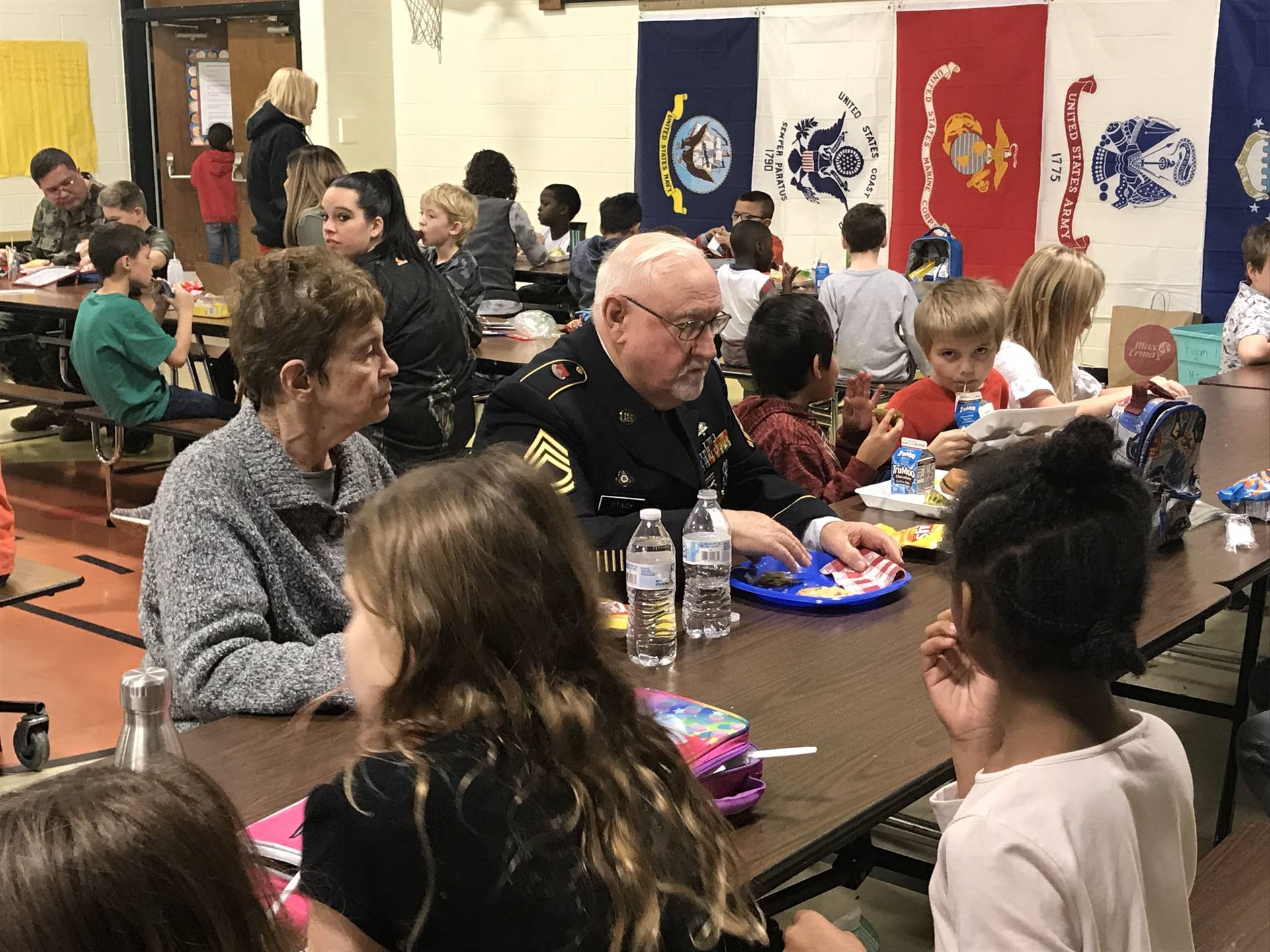 Veterans eating lunch with students