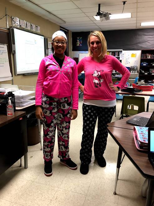 student & teacher dressed in pajamas