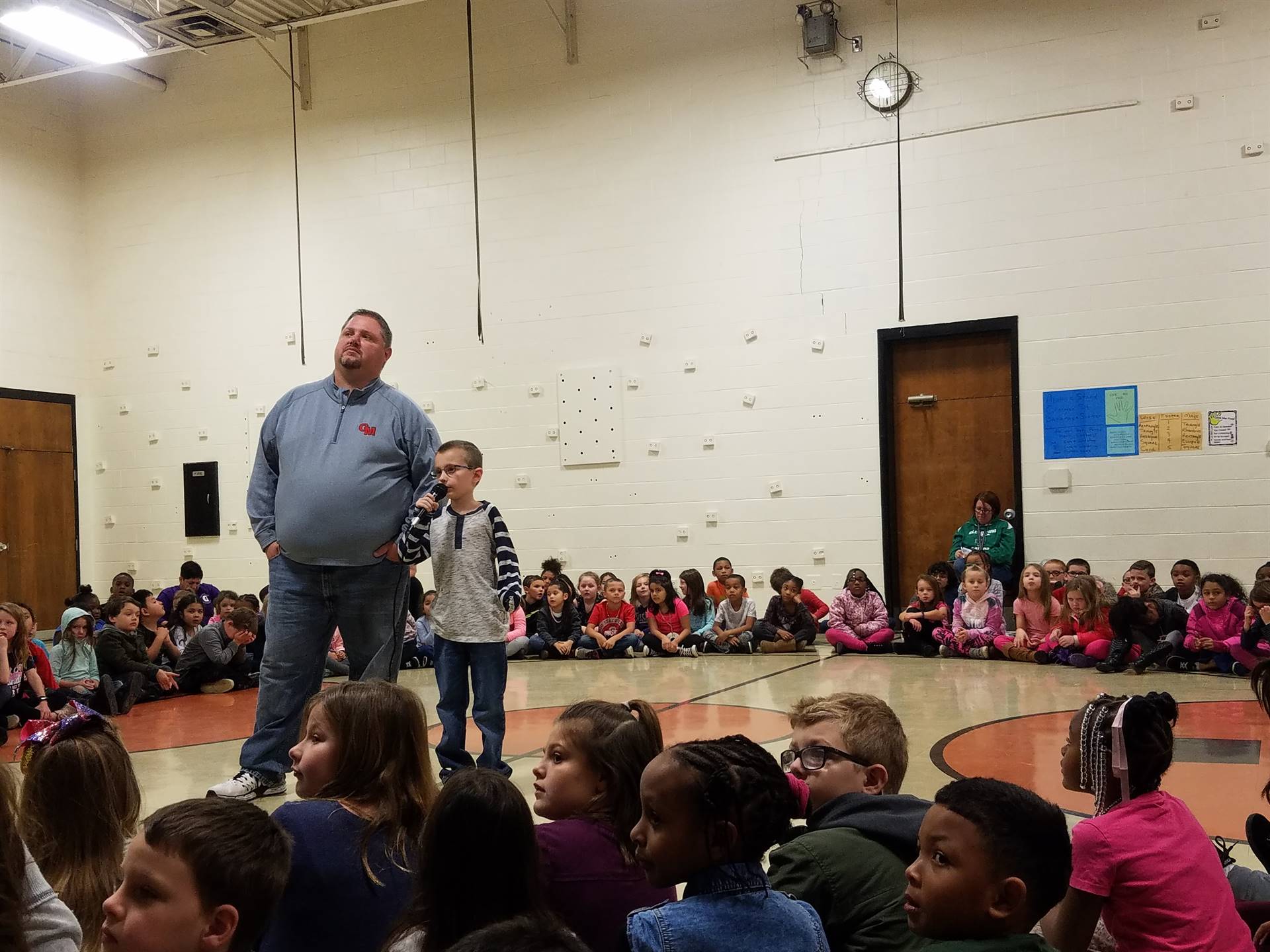 Child reading with Mr. Brogan