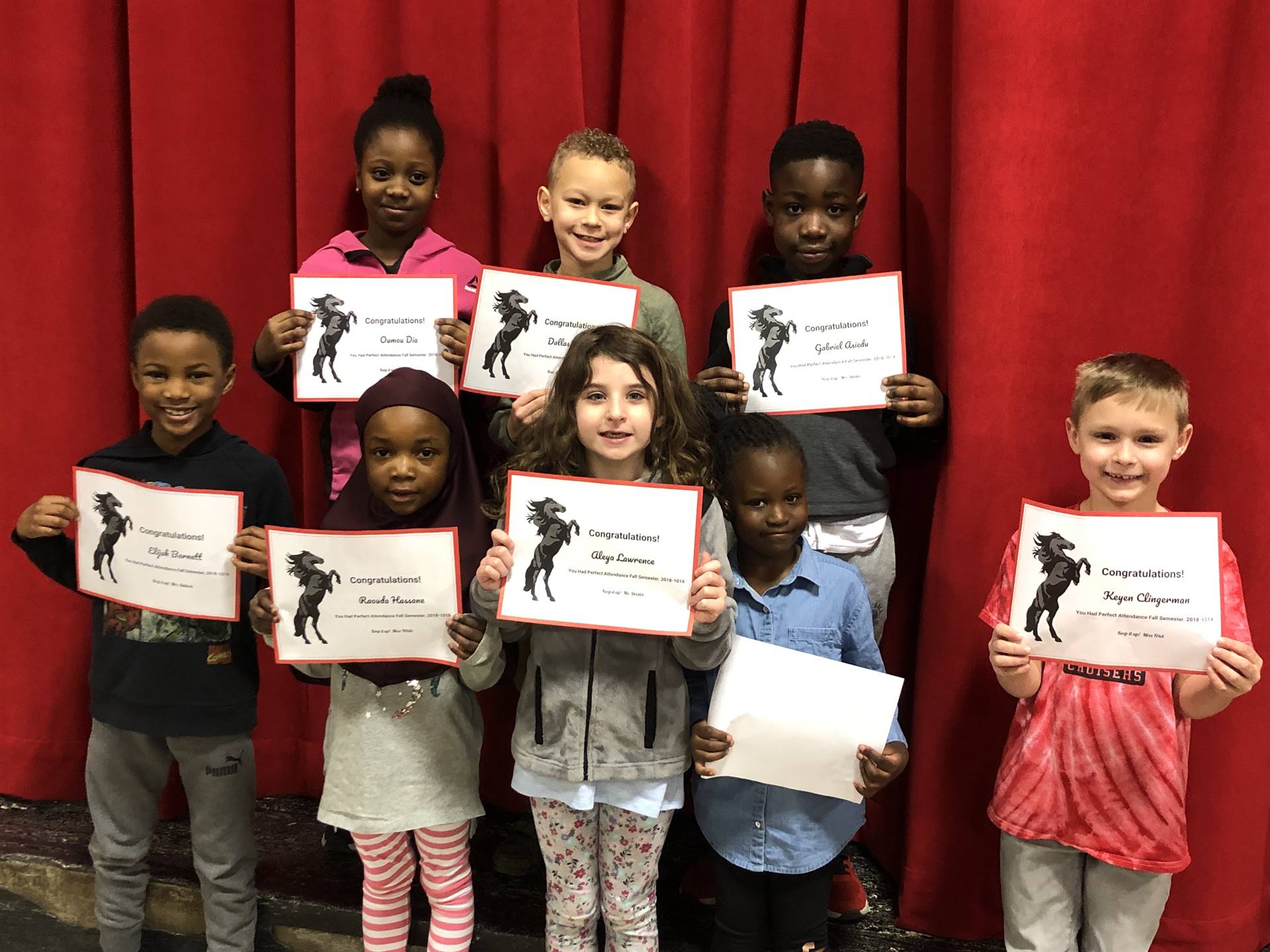 students holding paper certificates