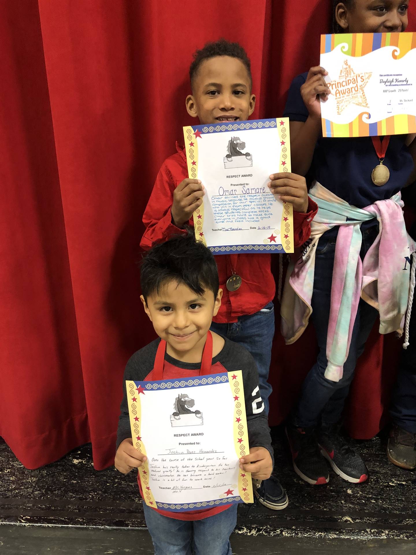 students holding paper certicites