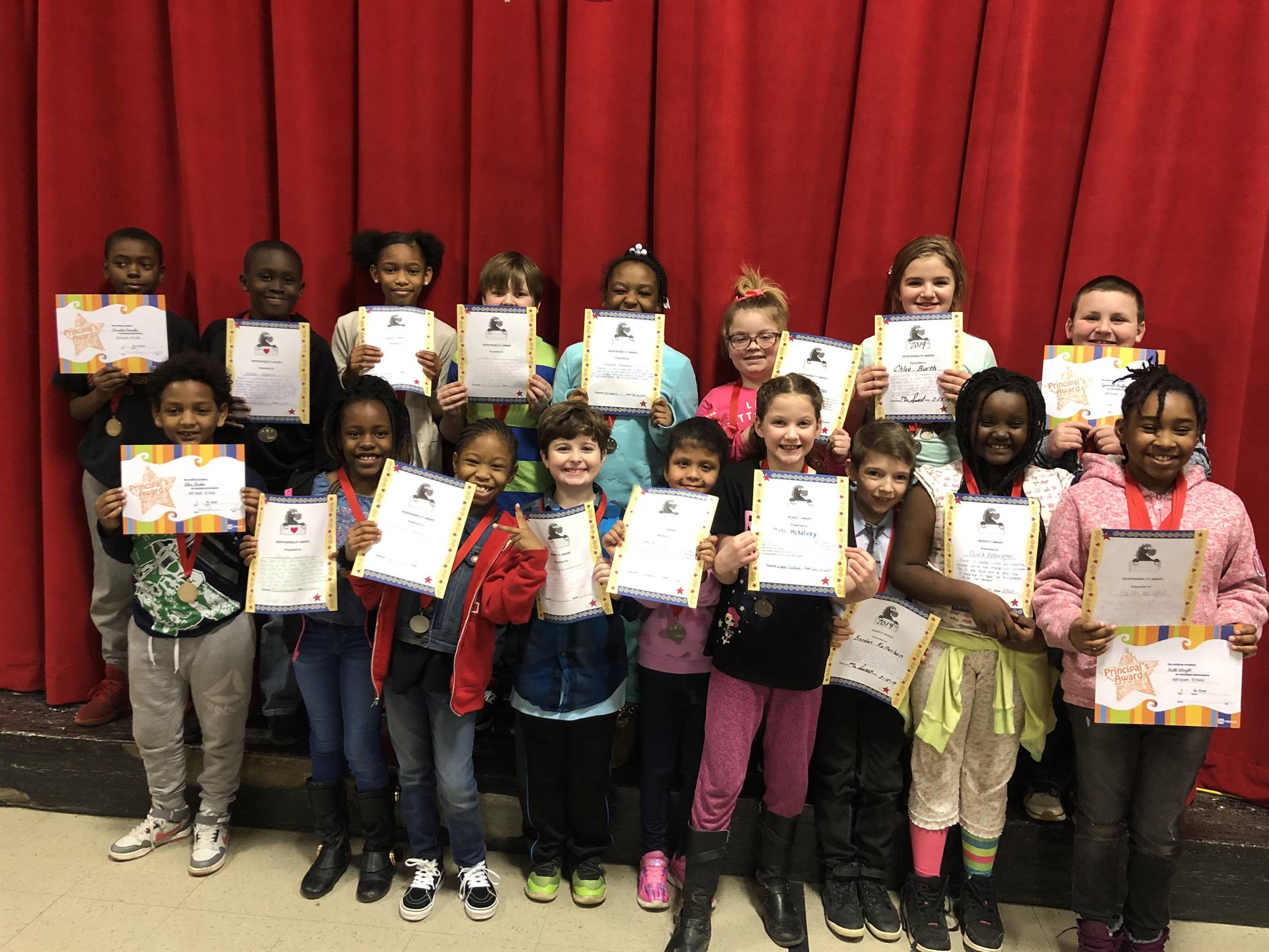 Students holding paper certifcicates