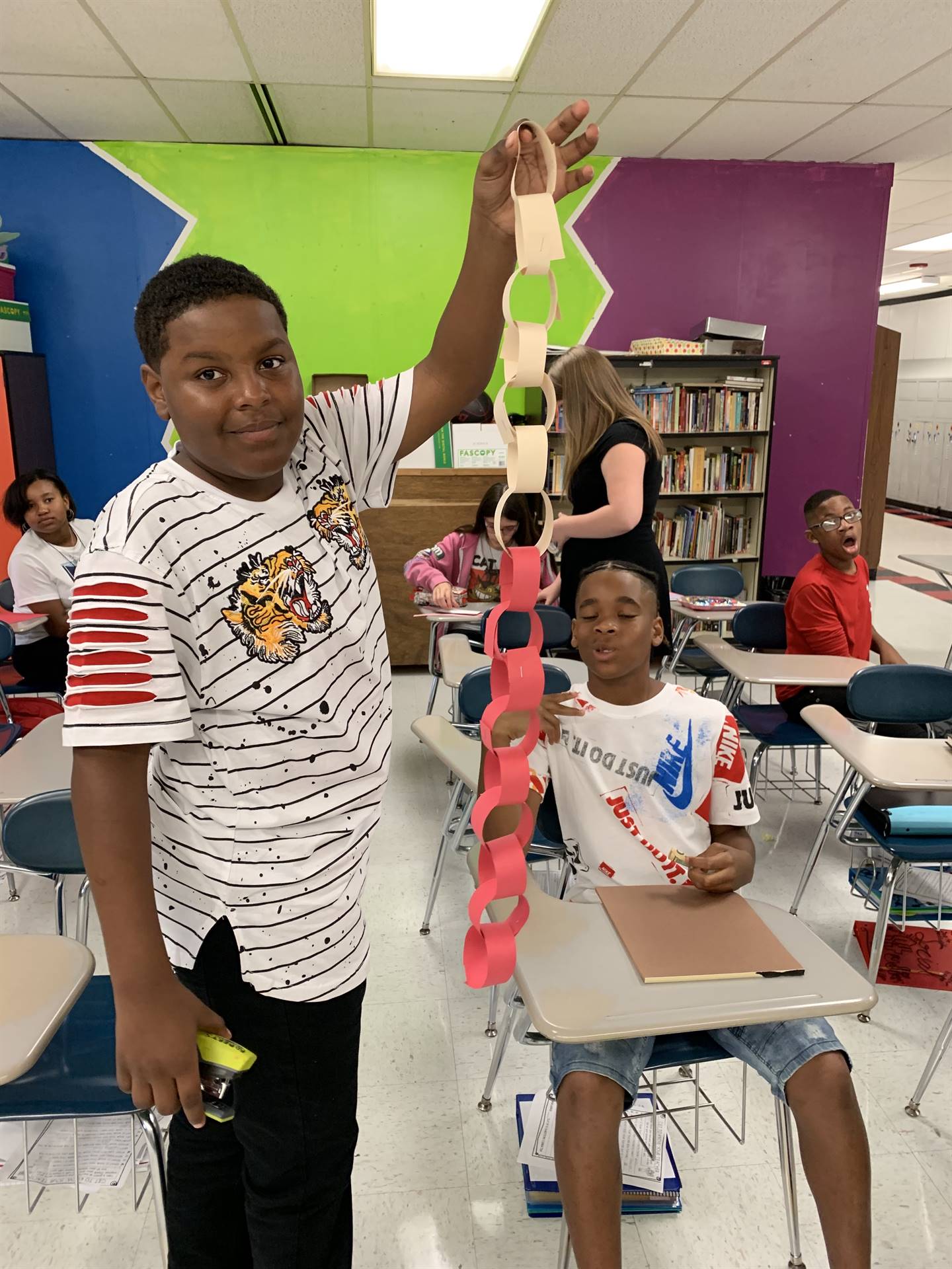 student with paper chain