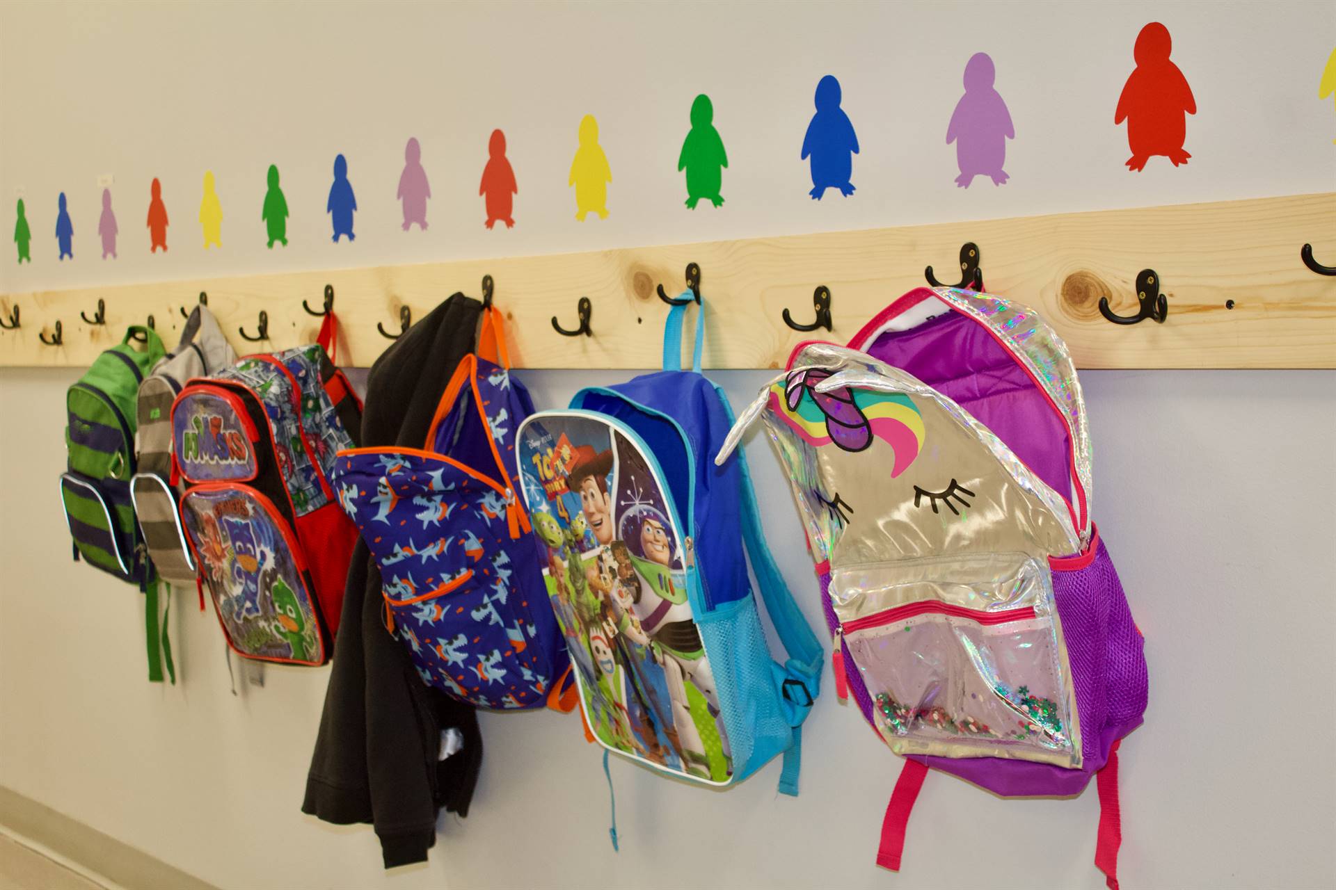 backpacks hanging on the wall