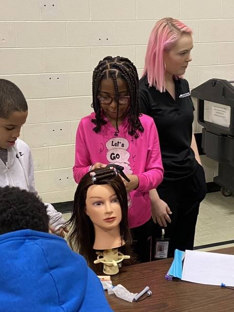 Students at the hair station