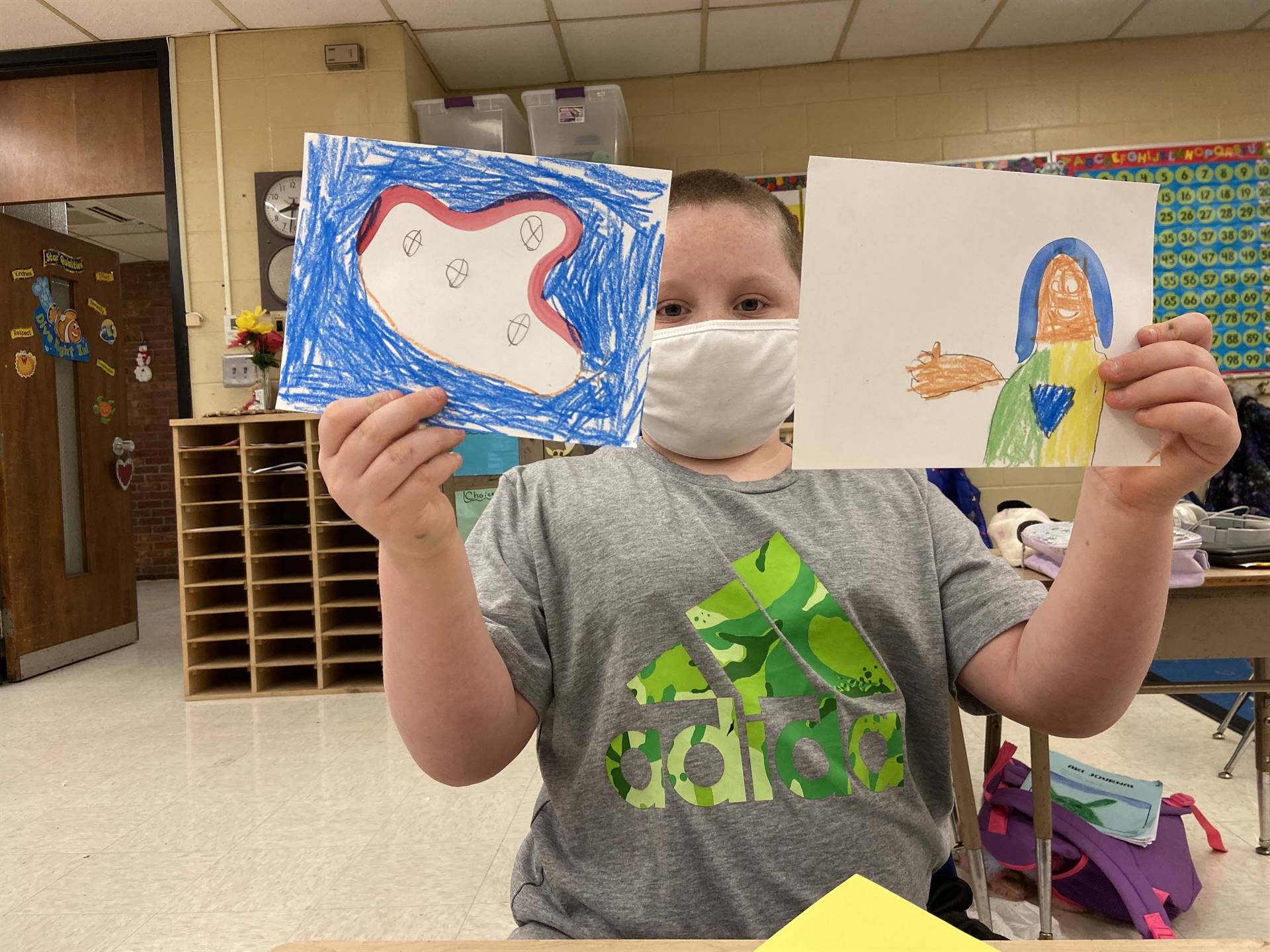 Student holding artwork