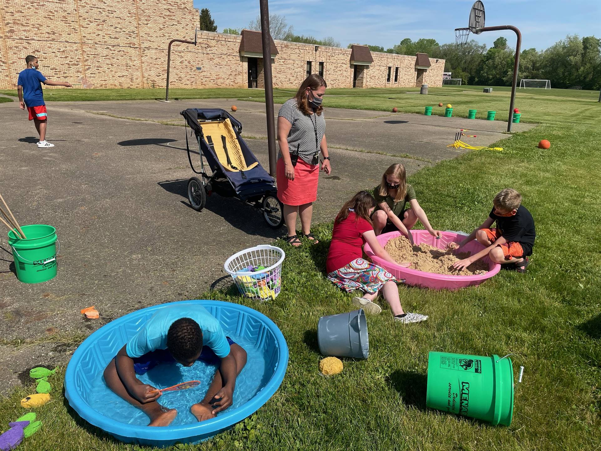 students  playing in pool and sand