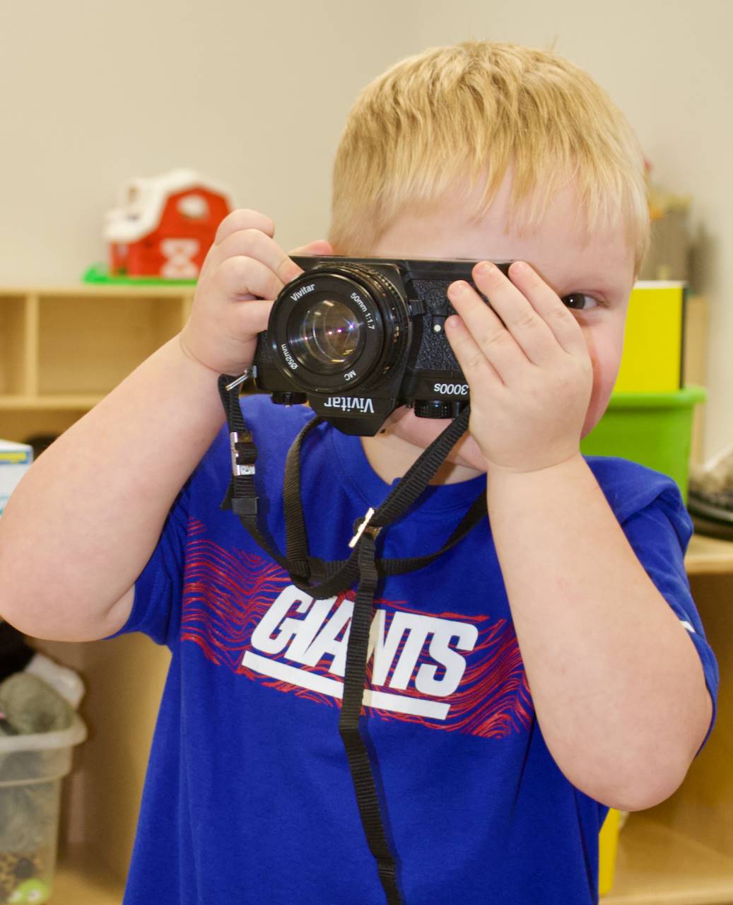 preschooler with camera