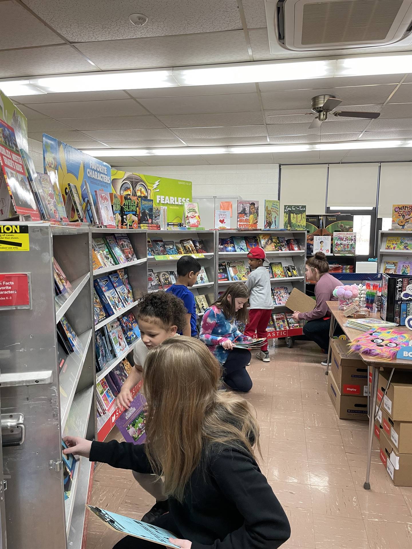 5th Grade Girls helping younger students at the book fair.