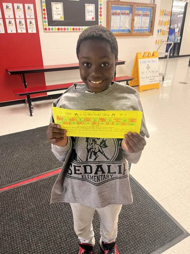 boy holding prize