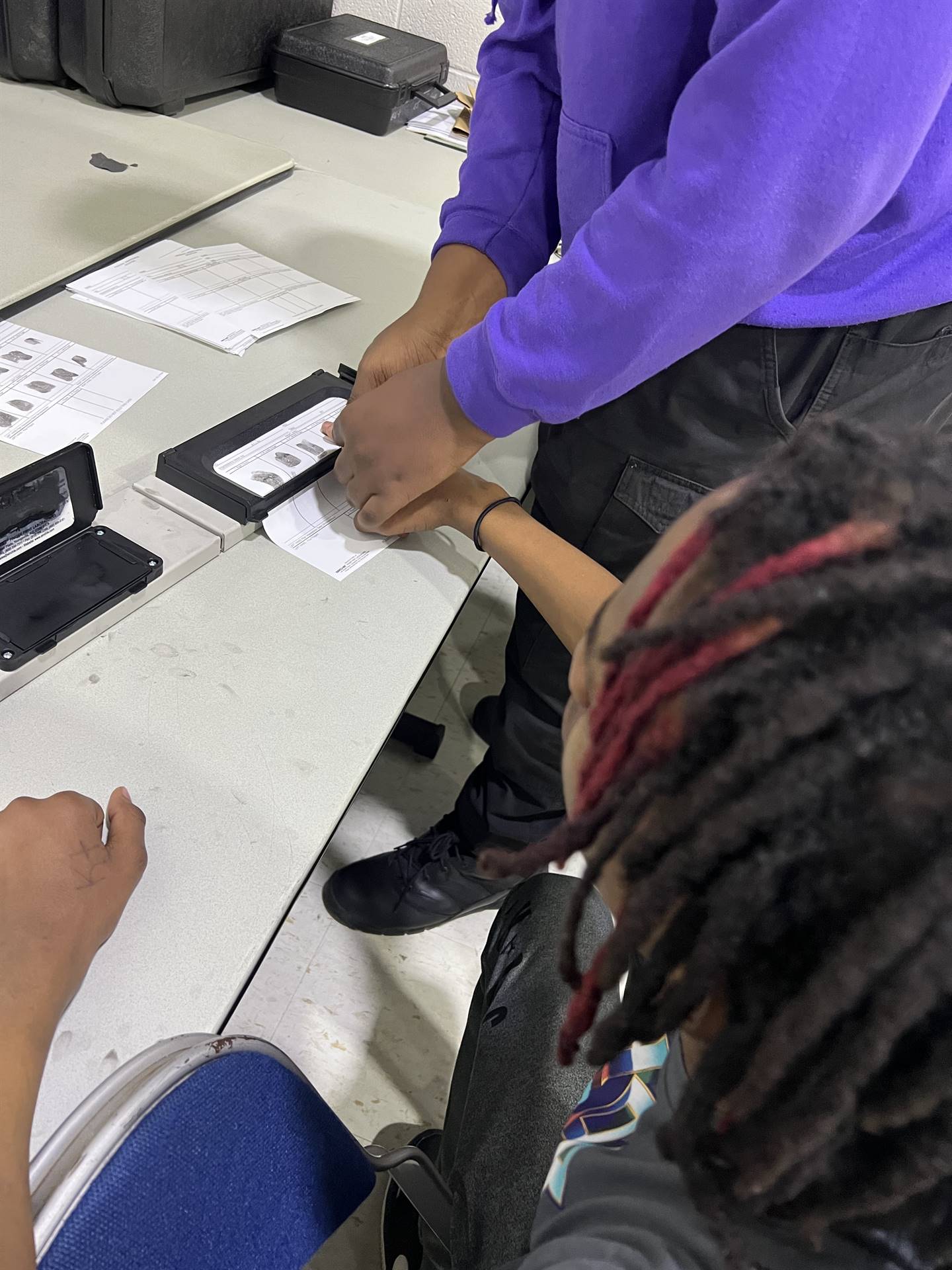 students being fingerprinted, learning about criminal justice