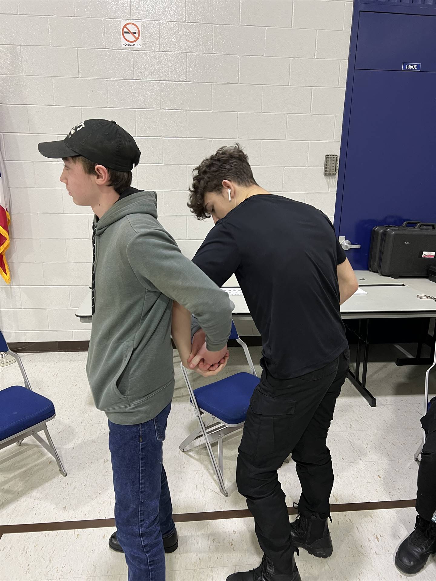 student being handcuffed, learning about criminal justice