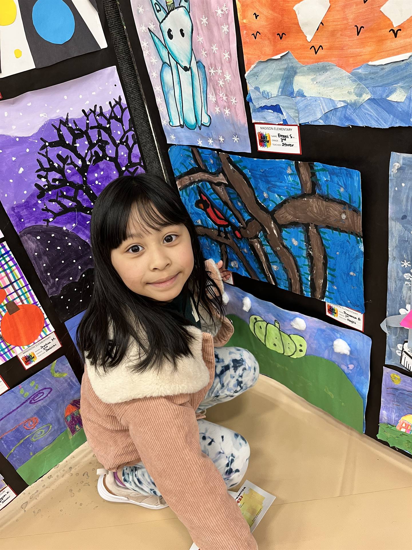 Students showing their artwork