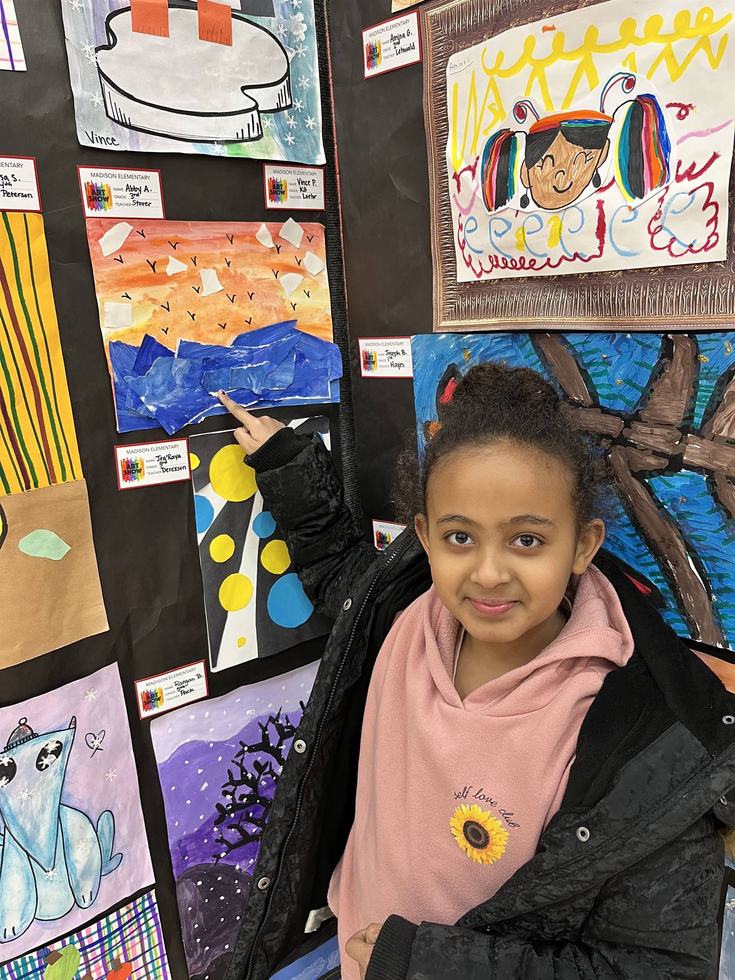 Students showing their artwork