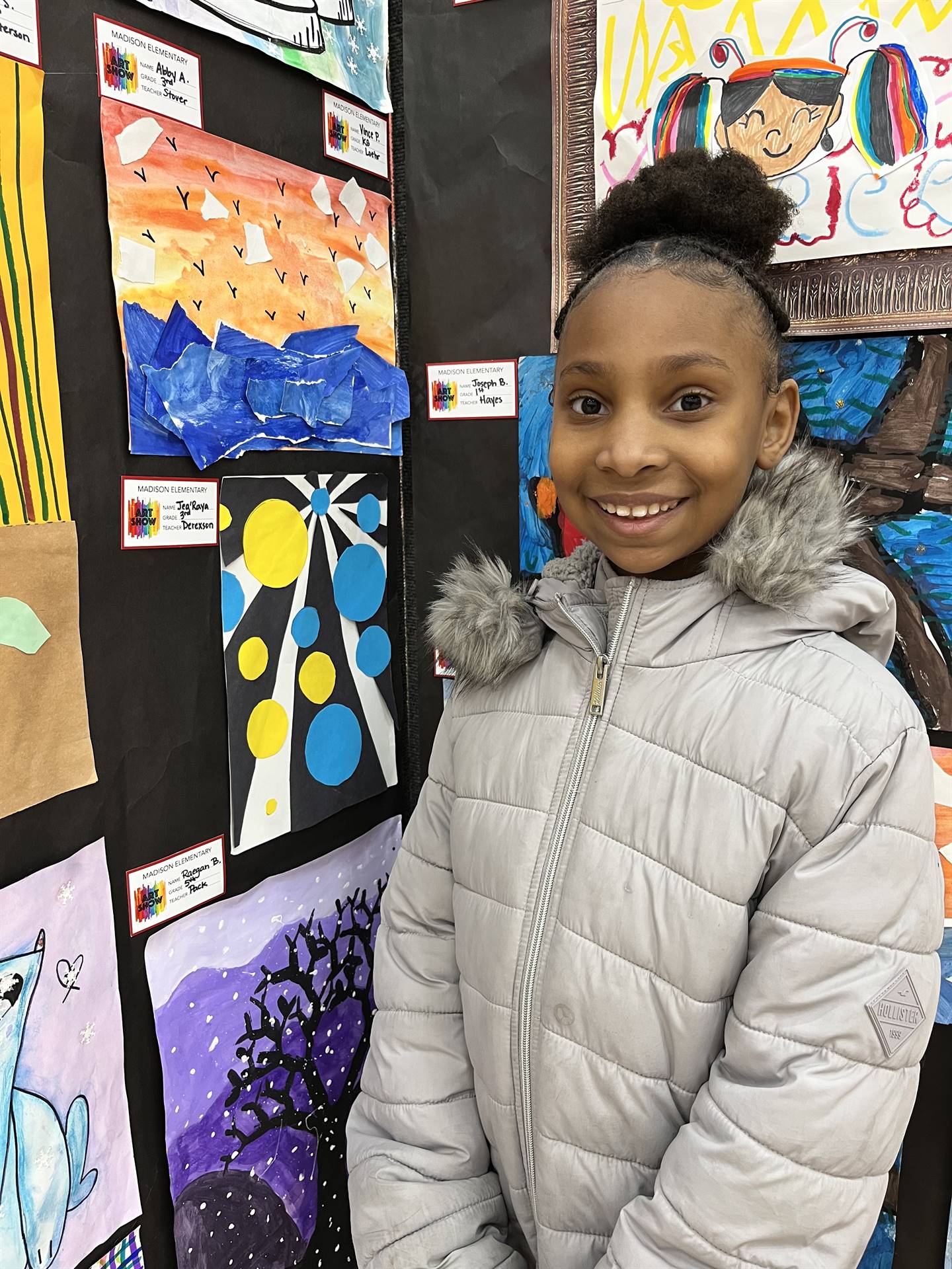 Students showing their artwork