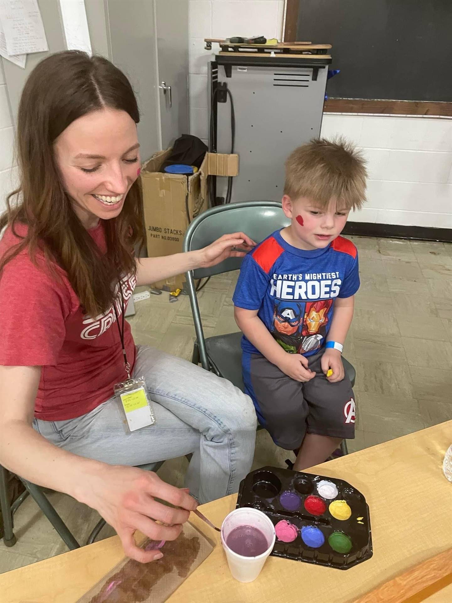 Teacher and student doing face painting