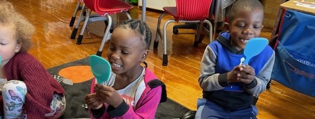 students smiling into mirrors