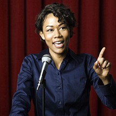 African-American woman speaking at podium
